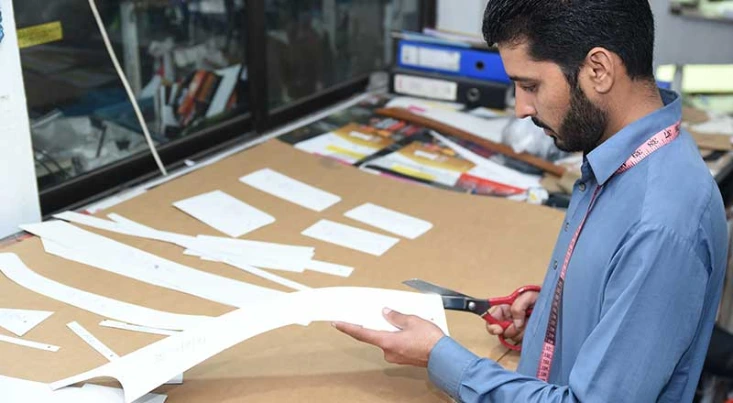 Garment pattern making and manual cutting process in apparel manufacturing facility